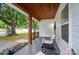 Inviting front porch with seating, a stained wood ceiling, and a view of the neighborhood at 118 Globe St, Mount Holly, NC 28120