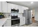 Well-lit kitchen features stainless steel appliances, white cabinets and a decorative backsplash at 118 Globe St, Mount Holly, NC 28120