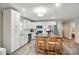 Open kitchen featuring white cabinets, stainless steel appliances, and an island with barstool seating at 118 Globe St, Mount Holly, NC 28120