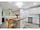 Spacious kitchen boasting an island with seating, white cabinets, and stainless steel appliances at 118 Globe St, Mount Holly, NC 28120