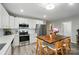 Bright kitchen features stainless steel appliances, white cabinets, and a wooden island with seating at 118 Globe St, Mount Holly, NC 28120