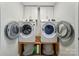 Updated laundry room with side-by-side washer and dryer, and storage cabinets at 118 Globe St, Mount Holly, NC 28120