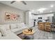 Open-concept living room with a modern kitchen featuring stainless steel appliances and an island with seating at 118 Globe St, Mount Holly, NC 28120