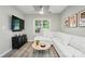 Living room showcasing a modern sofa, sleek entertainment center, and ample natural light at 118 Globe St, Mount Holly, NC 28120
