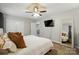This main bedroom boasts a ceiling fan, TV, modern flooring, and a mirror at 118 Globe St, Mount Holly, NC 28120