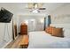 Bright main bedroom with wood-look floors, ceiling fan, and ensuite bathroom at 118 Globe St, Mount Holly, NC 28120