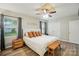 This main bedroom features a decorative ceiling, ceiling fan, and wood-look flooring at 118 Globe St, Mount Holly, NC 28120