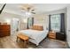 A spacious main bedroom with wood-look floors, ensuite bathroom, and ceiling fan at 118 Globe St, Mount Holly, NC 28120