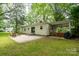 Exterior view of the home with patio, barbecue, and a firepit in the spacious backyard at 118 Marshdale Sw Ave, Concord, NC 28025