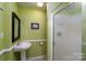 Bathroom with pedestal sink and walk-in shower at 118 Marshdale Sw Ave, Concord, NC 28025