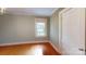A bright bedroom features hardwood floors and a window at 118 Marshdale Sw Ave, Concord, NC 28025