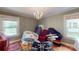 Cozy room featuring hardwood floors, dual windows, and a modern chandelier at 118 Marshdale Sw Ave, Concord, NC 28025