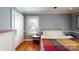 Bedroom with natural light, hardwood floors, and white trim at 118 Marshdale Sw Ave, Concord, NC 28025