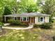 Charming single-story home with a brick facade, light siding, well-maintained lawn and beautiful, mature landscaping at 118 Marshdale Sw Ave, Concord, NC 28025