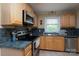 Efficient kitchen equipped with stainless steel appliances, natural light, and generous countertop space for effortless meal preparation at 118 Marshdale Sw Ave, Concord, NC 28025