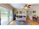A view of the living room with hardwood floors, a ceiling fan, and sliding glass doors that offer natural light at 118 Marshdale Sw Ave, Concord, NC 28025