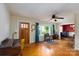 Bright living room features hardwood floors, natural light, a ceiling fan, and views into the cozy living space at 118 Marshdale Sw Ave, Concord, NC 28025