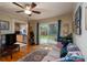The comfortable living room includes hardwood floors, a ceiling fan, and natural light from the backyard at 118 Marshdale Sw Ave, Concord, NC 28025
