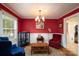 Formal dining room with rich red walls, a stylish chandelier, and elegant decor, perfect for hosting gatherings at 118 Marshdale Sw Ave, Concord, NC 28025