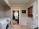Functional mud room featuring laundry appliances, tiled flooring, and easy access to adjacent room, adding convenience to daily life at 118 Marshdale Sw Ave, Concord, NC 28025