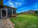 Lush backyard featuring a screened porch, a garden planter, and a gently sloping lawn, offering a serene outdoor space at 1190 Arges River Dr, Fort Mill, SC 29715