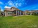 Expansive backyard with screened porch, pergola-covered outdoor kitchen, and lush green lawn extending to the fence at 1190 Arges River Dr, Fort Mill, SC 29715