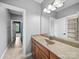 Bathroom with wood cabinets, large mirror, and granite countertops at 1190 Arges River Dr, Fort Mill, SC 29715