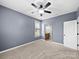 Neutral carpeted bedroom featuring a ceiling fan and plenty of natural light at 1190 Arges River Dr, Fort Mill, SC 29715