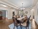 Formal dining room features a wooden table with seating for eight, chandelier, and hardwood floors at 1190 Arges River Dr, Fort Mill, SC 29715