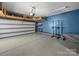 Spacious garage with high ceilings, overhead storage, and an epoxy floor perfect for car enthusiasts at 1190 Arges River Dr, Fort Mill, SC 29715