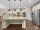 Spacious kitchen featuring a large island, stainless steel appliances and hardwood floors at 1190 Arges River Dr, Fort Mill, SC 29715