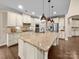 Kitchen with a large island, stainless steel appliances, granite countertops and hardwood flooring at 1190 Arges River Dr, Fort Mill, SC 29715