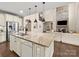 Kitchen with a large island and open view to the living room and fireplace at 1190 Arges River Dr, Fort Mill, SC 29715