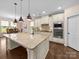 Bright kitchen features a large island, granite countertops, stainless steel appliances and hardwood flooring at 1190 Arges River Dr, Fort Mill, SC 29715