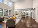 Open-concept living room featuring lots of windows, hardwood floors, and modern lighting at 1190 Arges River Dr, Fort Mill, SC 29715