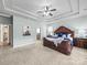 Spacious primary bedroom features a tray ceiling, elegant furniture, and a cozy carpet for ultimate comfort and style at 1190 Arges River Dr, Fort Mill, SC 29715
