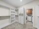 Custom walk-in closet with built-in organizers, shelves, and drawers adjacent to the laundry room for convenience at 1190 Arges River Dr, Fort Mill, SC 29715