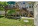 Multi-tiered deck overlooks lush backyard, with stairs leading to a patio and garden area at 12125 Mountainside Ln, Charlotte, NC 28278