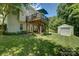 Expansive backyard features a two-level deck, lush lawn, and a storage shed at 12125 Mountainside Ln, Charlotte, NC 28278