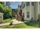 Landscaped backyard featuring a spacious deck with stairs and mature trees at 12125 Mountainside Ln, Charlotte, NC 28278