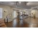 Basement game area features ping pong table, utility sink, and access to the outside with wood-look flooring at 12125 Mountainside Ln, Charlotte, NC 28278