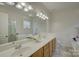 Bright bathroom with double sinks, white cabinets, and a bathtub providing plenty of space and style at 12125 Mountainside Ln, Charlotte, NC 28278