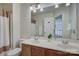 Bright bathroom features double sinks, a large mirror, and a shower with curtain at 12125 Mountainside Ln, Charlotte, NC 28278