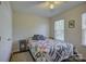 Comfortable bedroom with a quilt-covered bed, a side table, and a window, creating a cozy retreat at 12125 Mountainside Ln, Charlotte, NC 28278