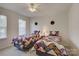 Charming bedroom with two twin beds featuring colorful quilts, creating a cozy and inviting space at 12125 Mountainside Ln, Charlotte, NC 28278