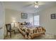 Cozy bedroom featuring a charming patchwork quilt, soft lighting, and a ceiling fan at 12125 Mountainside Ln, Charlotte, NC 28278