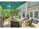 View of the deck showing stylish outdoor seating, shade umbrella, and access to the home at 12125 Mountainside Ln, Charlotte, NC 28278
