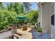 Spacious deck with outdoor seating, a large umbrella, and view of mature trees and lawn at 12125 Mountainside Ln, Charlotte, NC 28278
