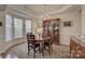 Elegant dining room with chandelier and a hutch, illuminated by natural light from the bay windows at 12125 Mountainside Ln, Charlotte, NC 28278