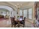 Bright dining room featuring a chandelier, bay window, and access to the living area at 12125 Mountainside Ln, Charlotte, NC 28278